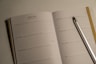 a notebook with a pen and a notebook