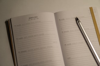a notebook with a pen and a notebook