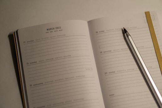 a notebook with a pen and a notebook