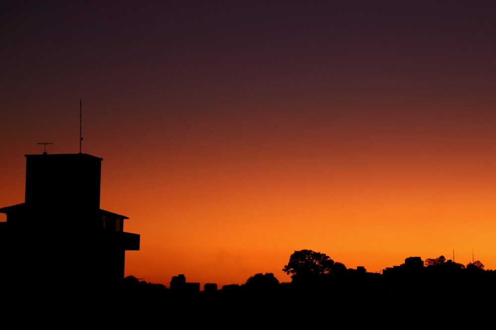 silhouette of a building and a sunset