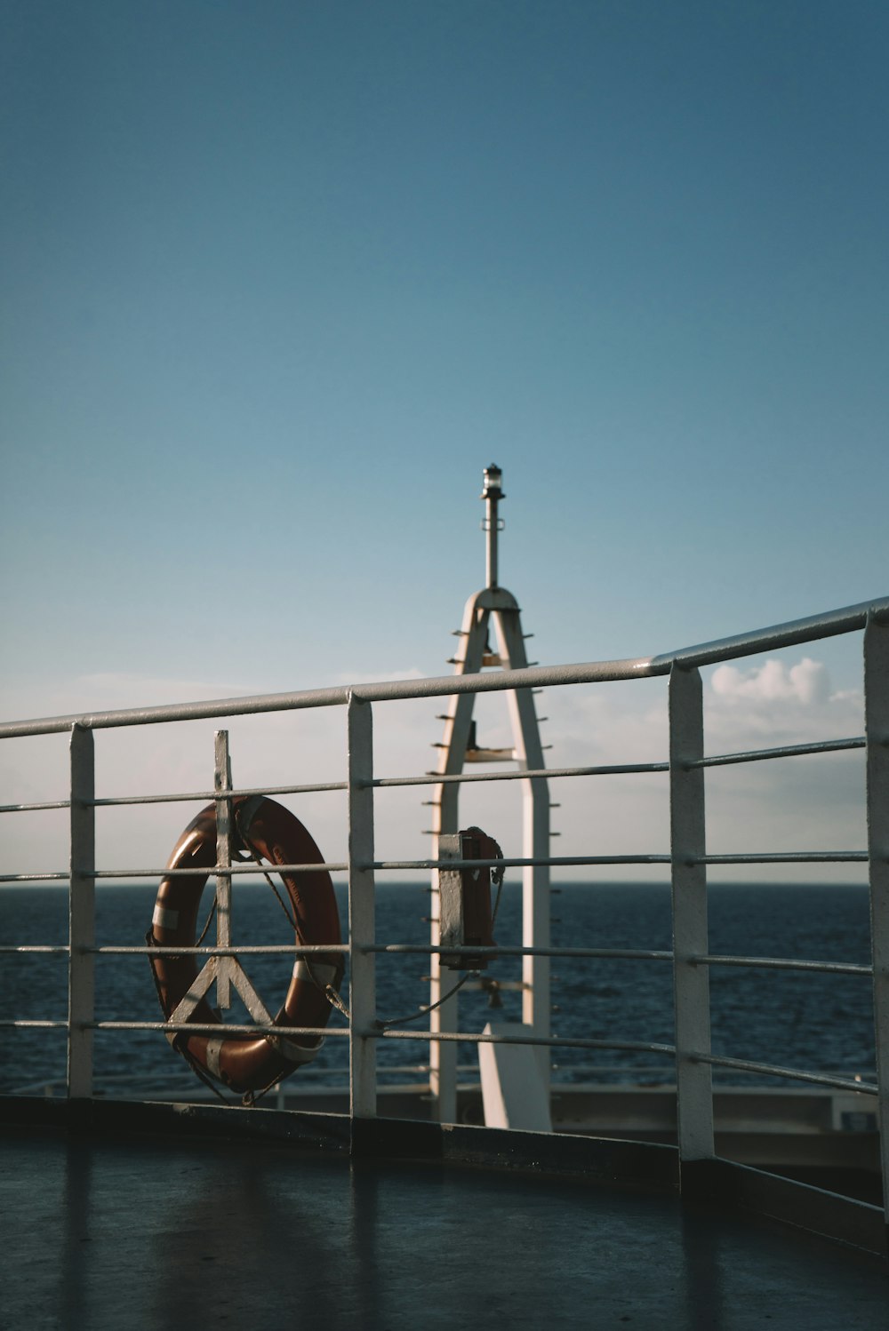 a woman's feet on a metal railing over water