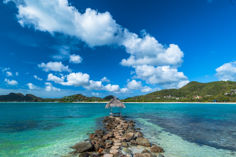 a rocky beach with a hut