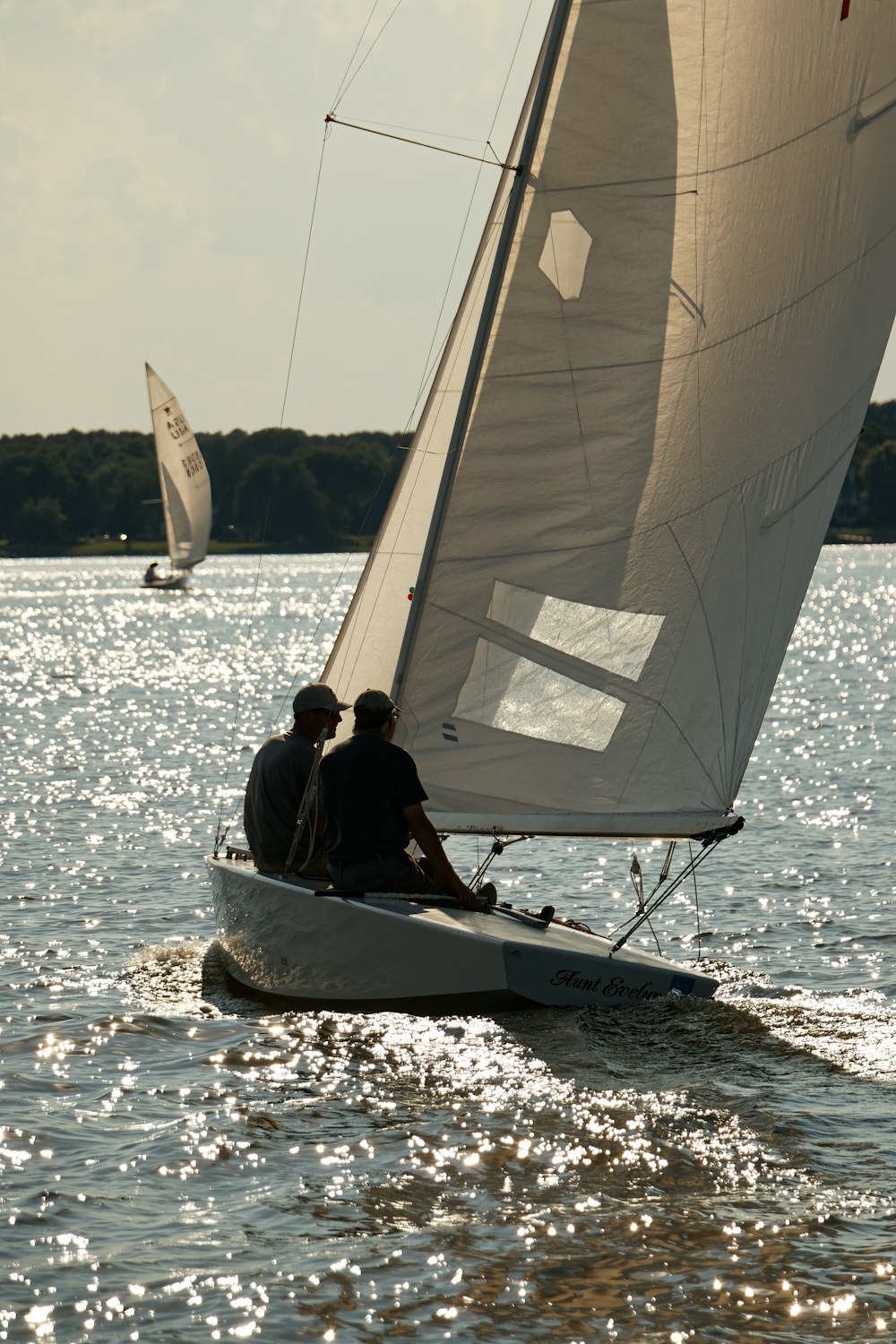 a couple of men sailing on a boat