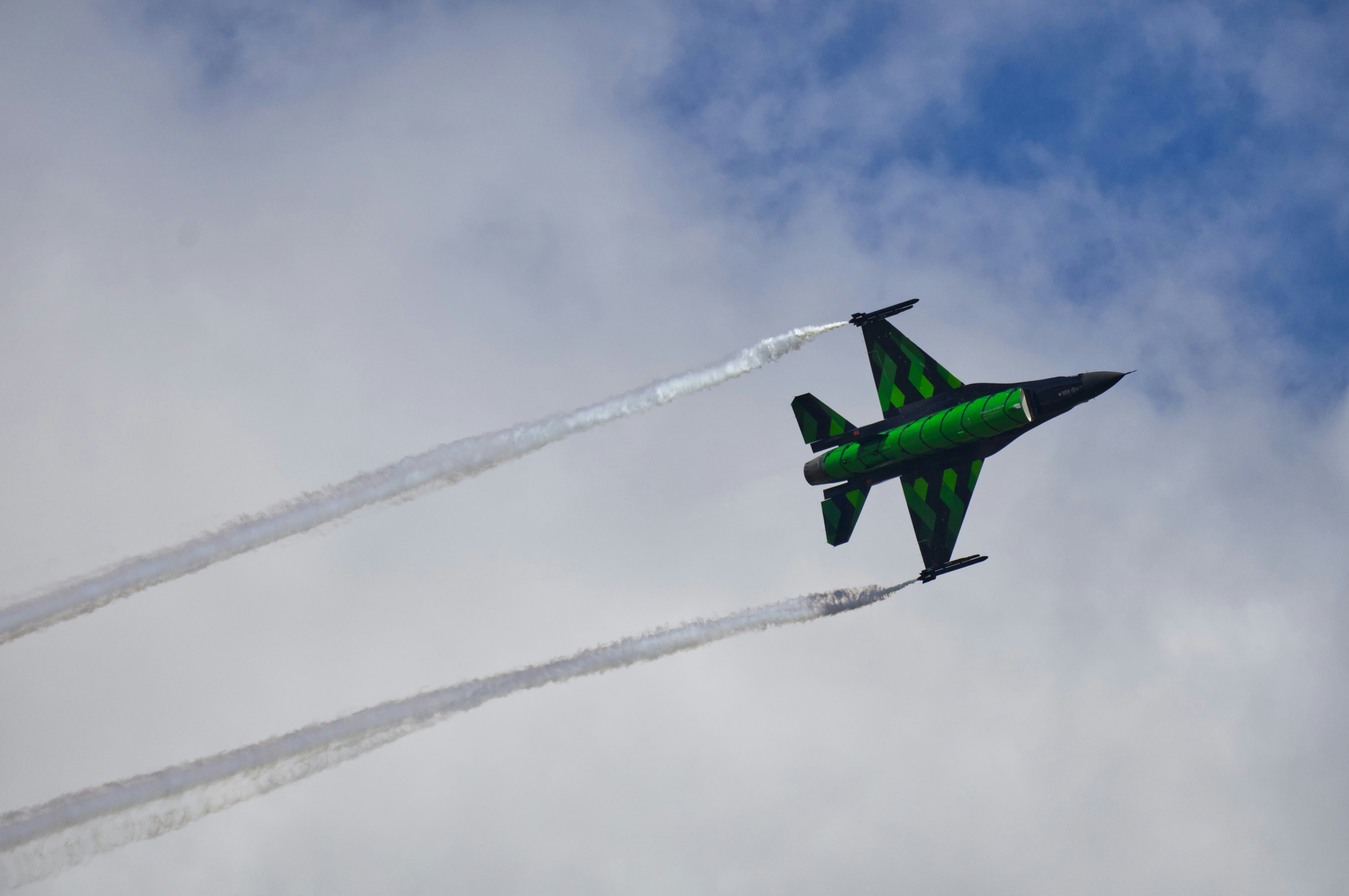 A green airplane flying in the sky photo – Free Zeltweg Image on Unsplash