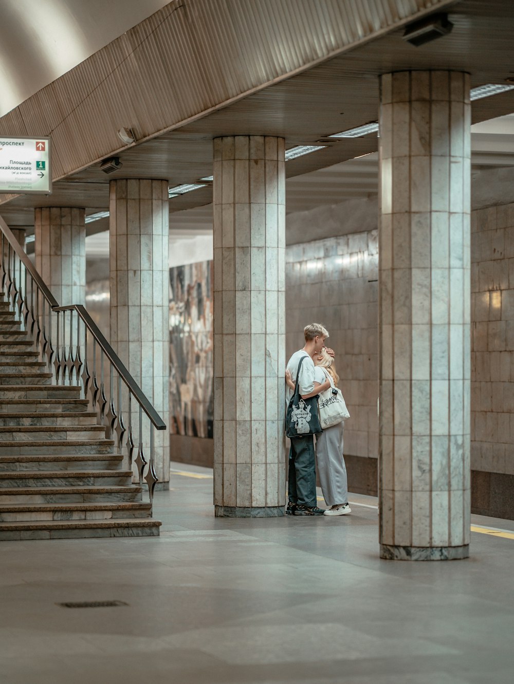 a man and woman standing in front of a building