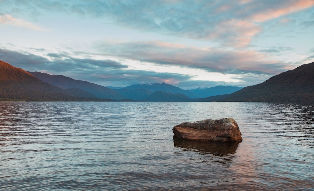 a rock in the middle of a body of water