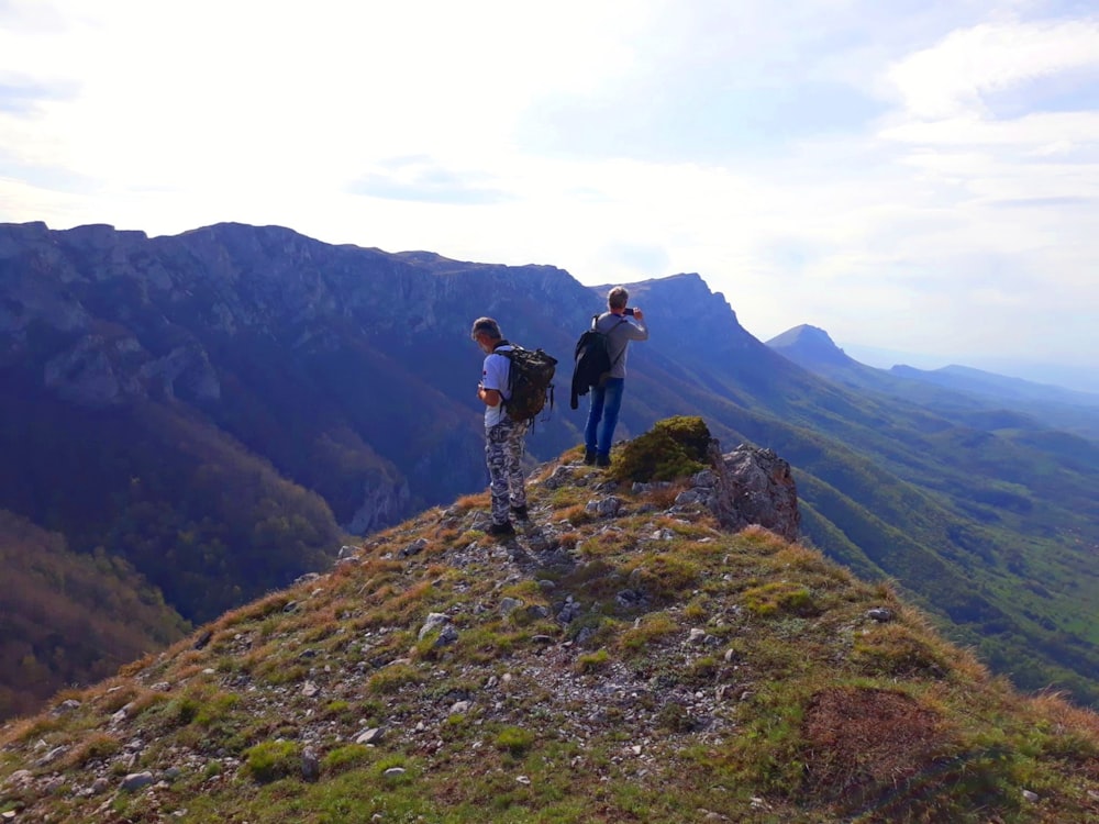 a couple of people on a mountain