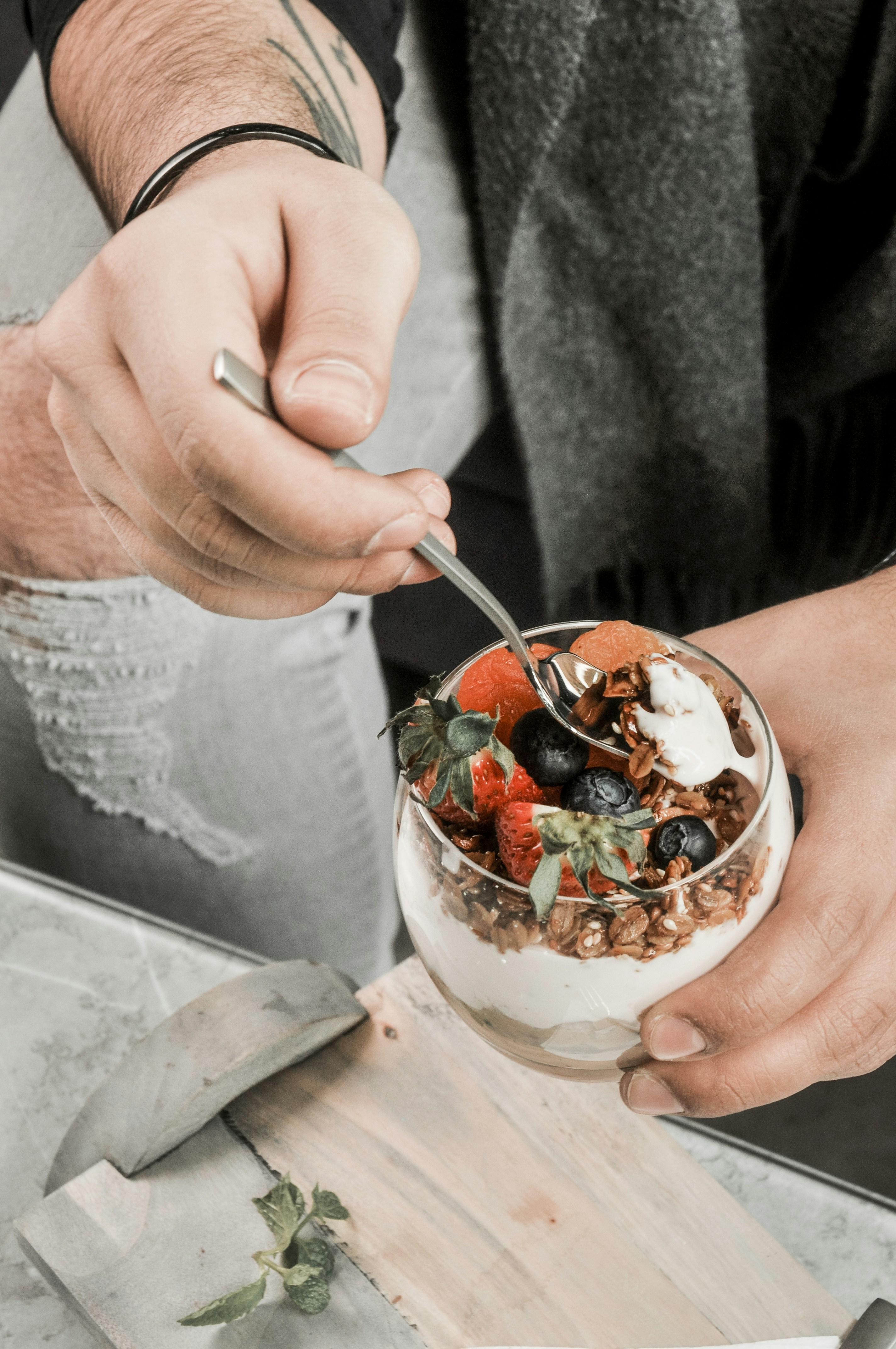 a person eating a bowl of fruit