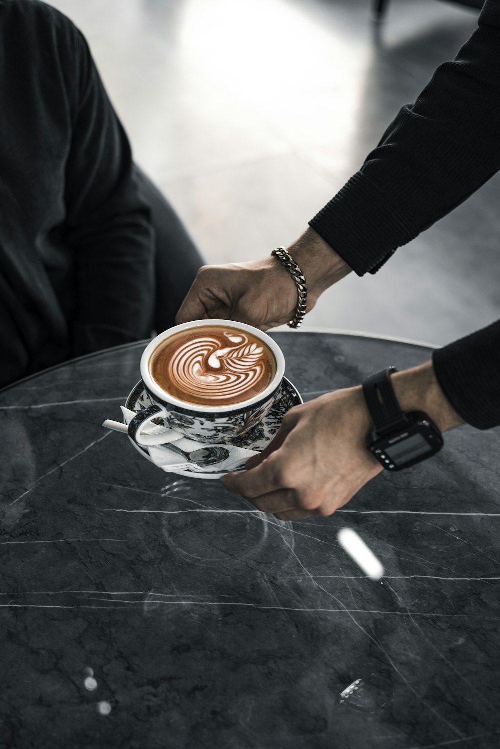 a person holding a cup of coffee