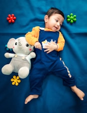 a boy holding a stuffed animal