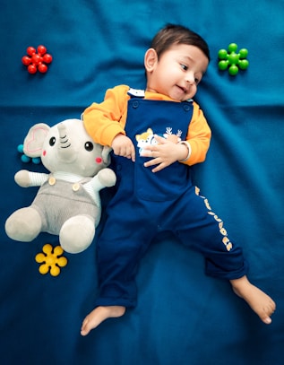 a boy holding a stuffed animal