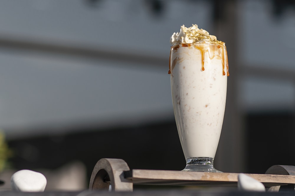 a glass of milk with a spoon