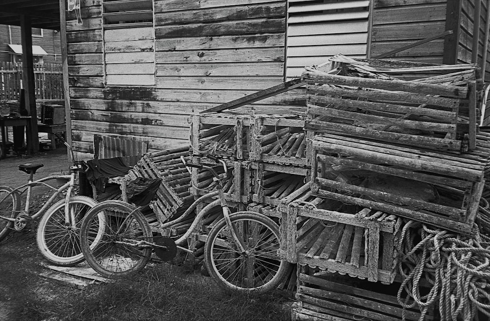 bicycles parked next to a pile of wood