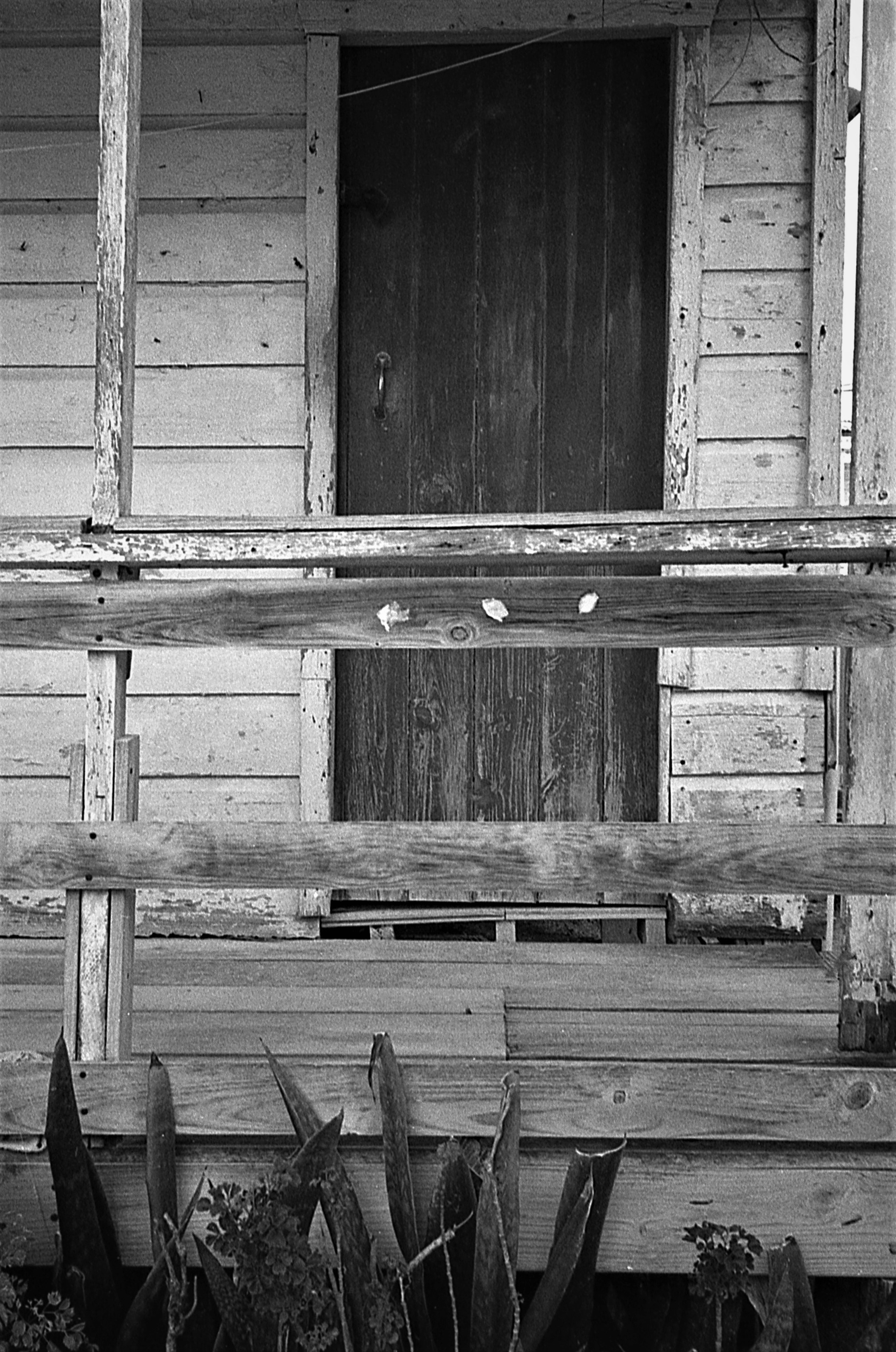 a wooden building with a fence