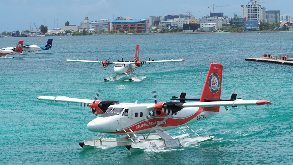 a group of airplanes flying over water