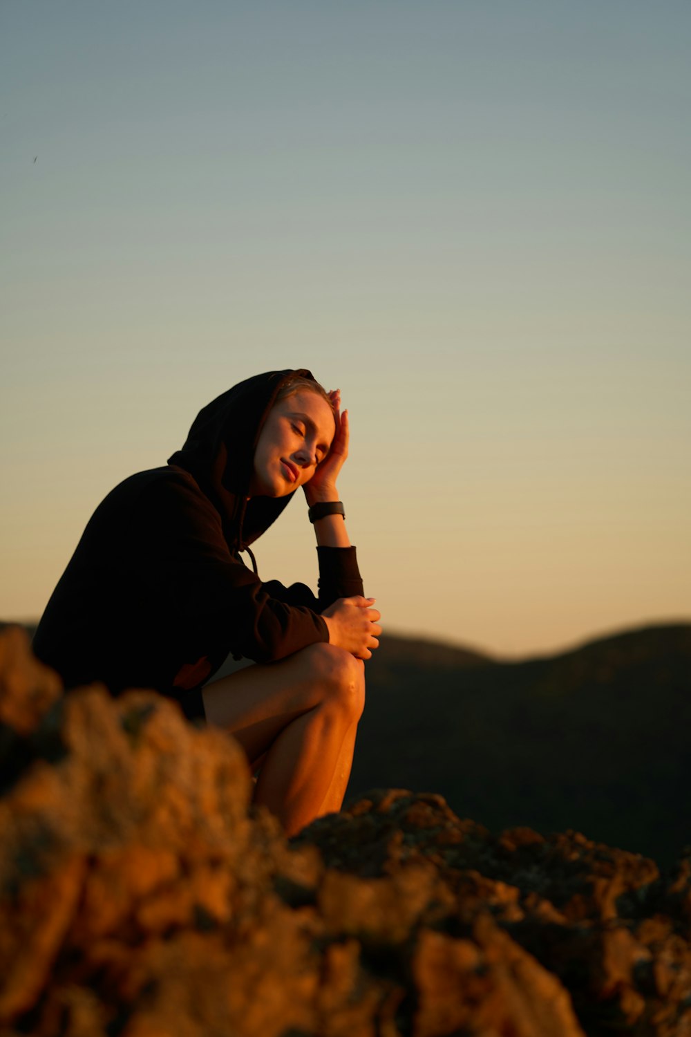 a man sitting on a rock