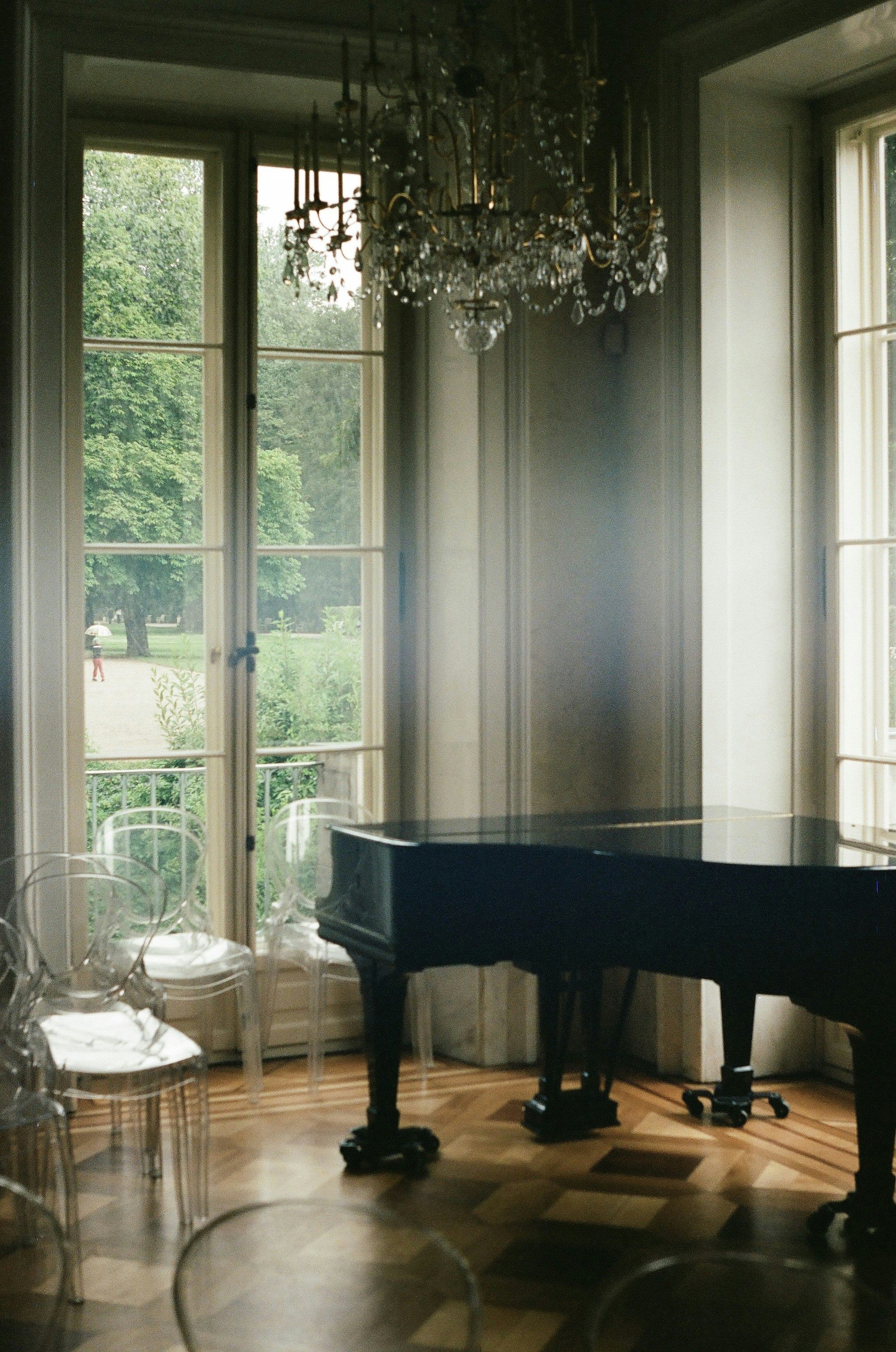a chandelier from a ceiling in a room with windows