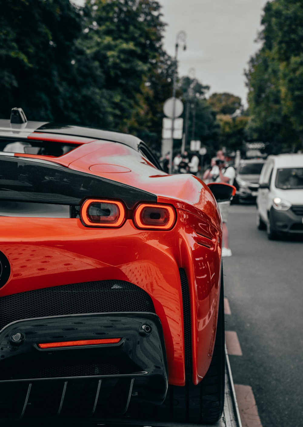 a red sports car parked on the side of a road