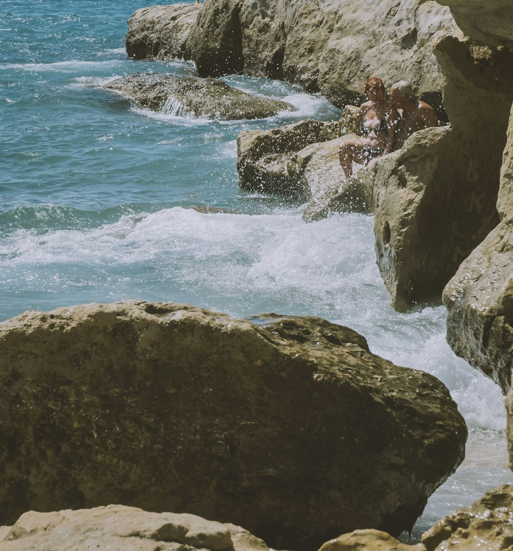 a rocky beach with waves crashing against it