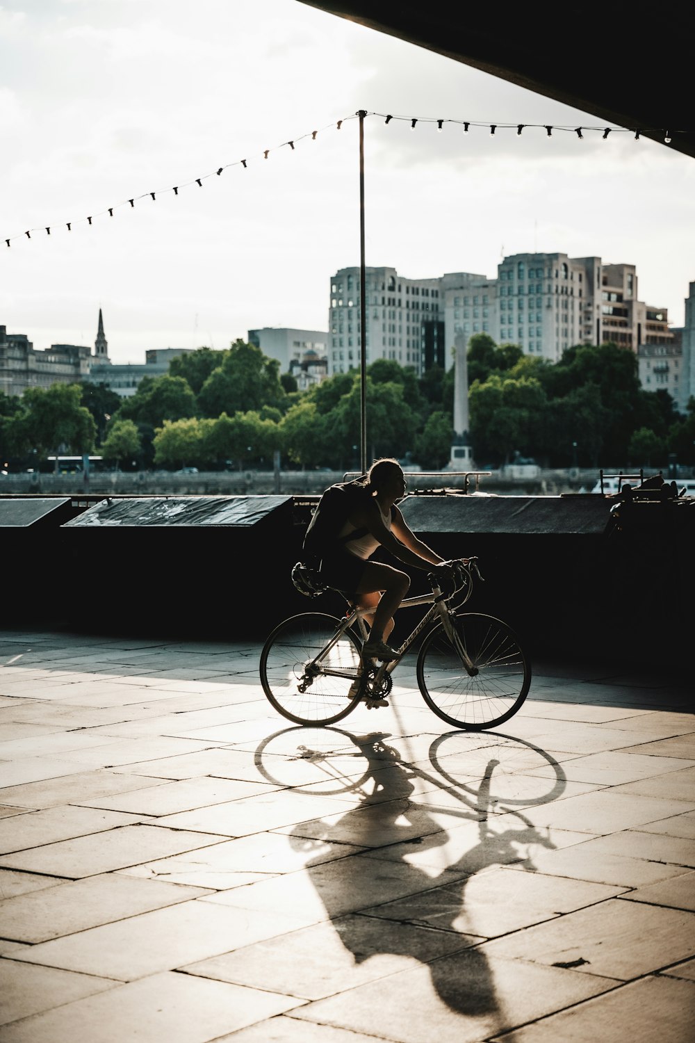 a person riding a bike on a bridge