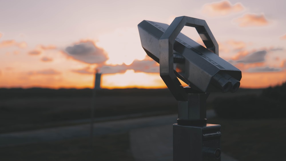 a machine with a sunset in the background