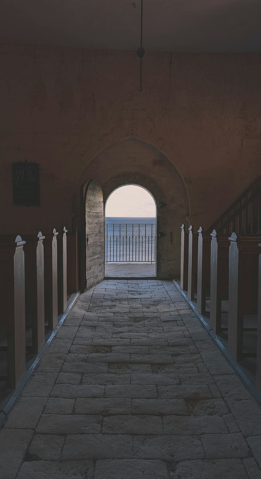 a stone walkway with a gate