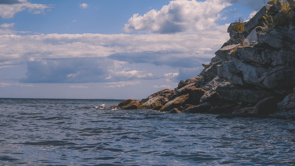 a rocky cliff next to the ocean