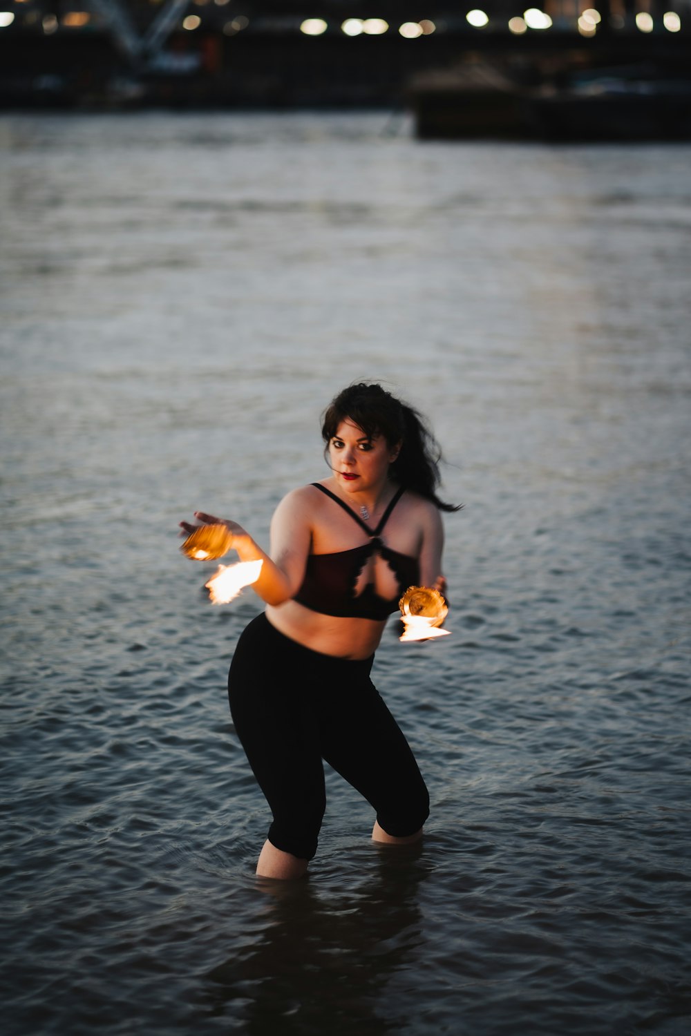 a person in a body of water holding a crab