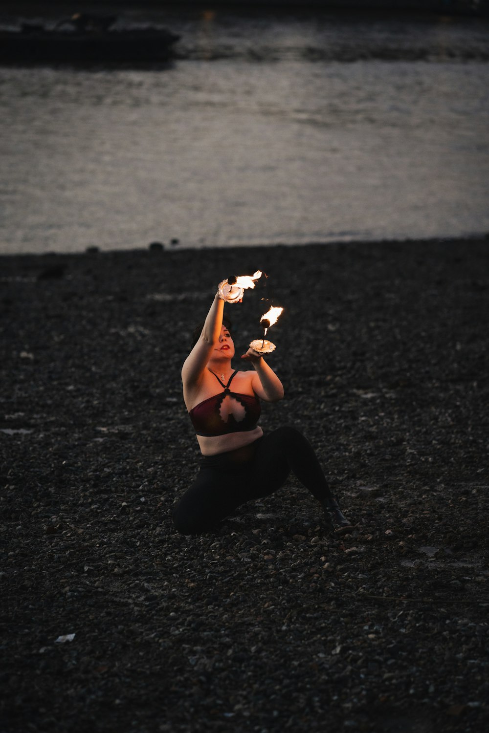 a woman lying on the ground holding a bottle of alcohol