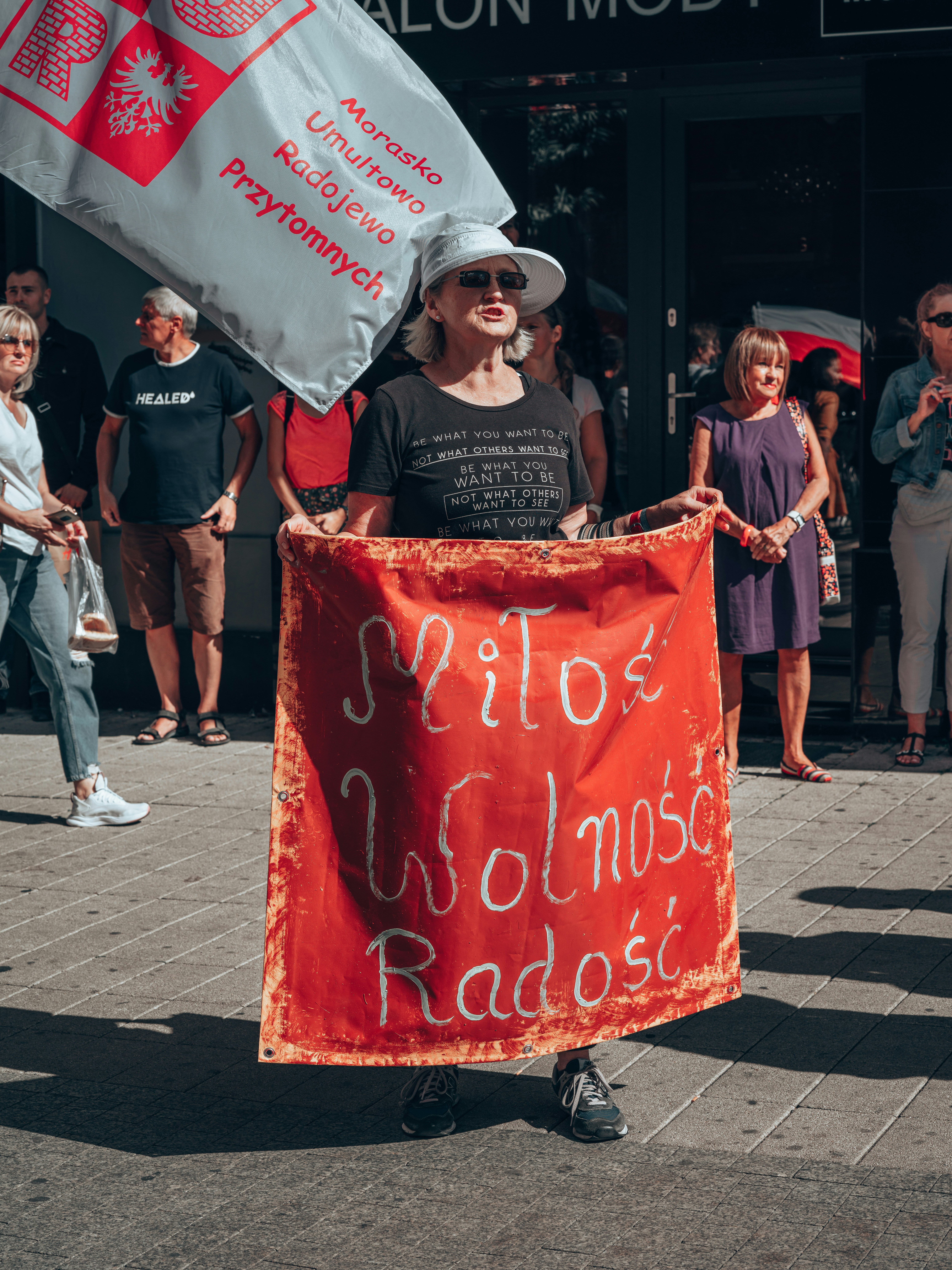 a person holding a red sign