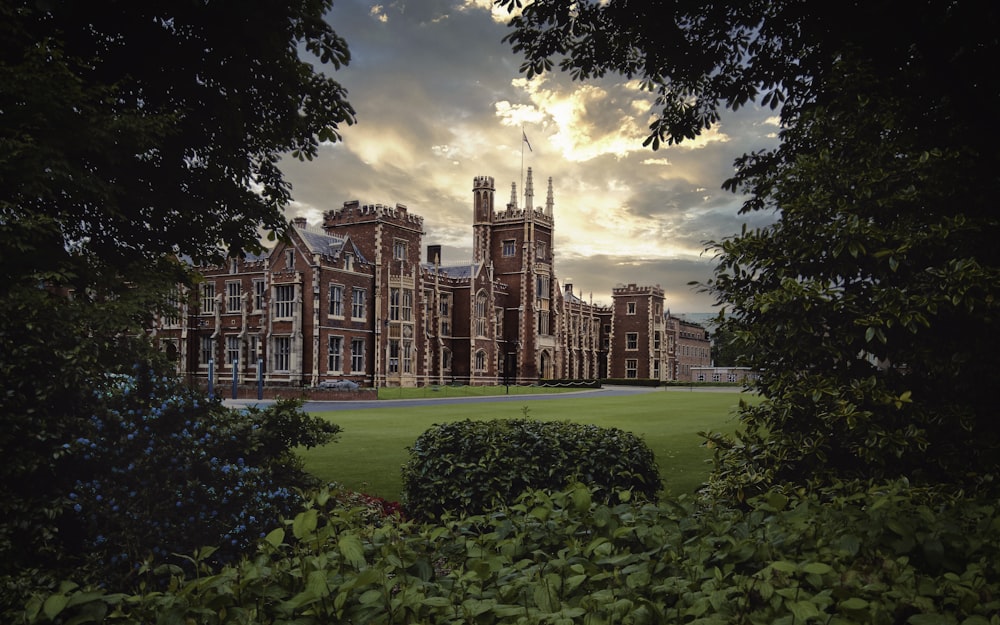 a large building with a lawn in front of it