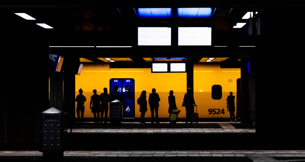 a group of people standing in a train station