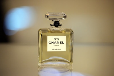 Chanel perfume bottle with a minimalist backdrop highlighting its classic design.
