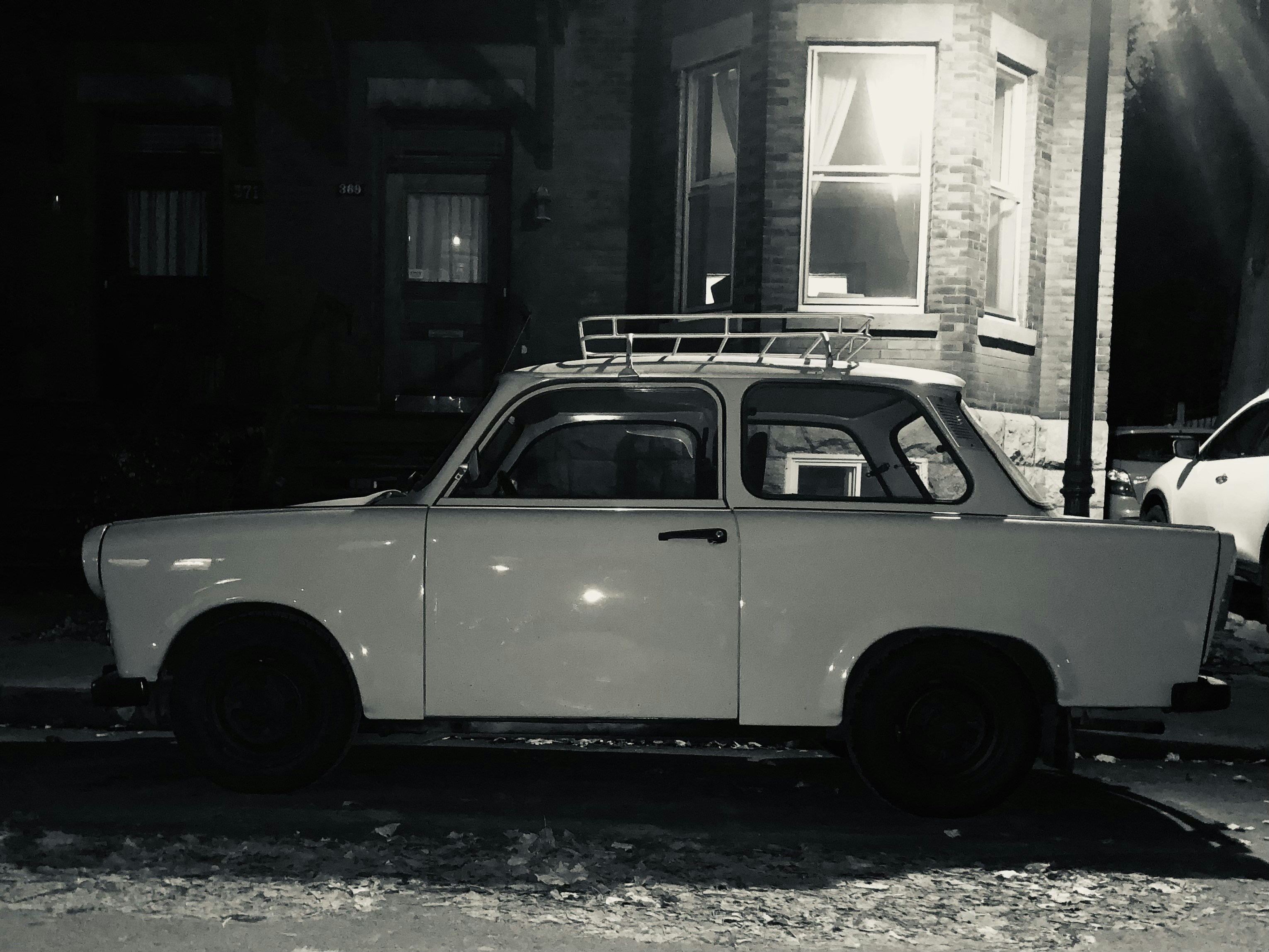 a white car parked on the side of a street