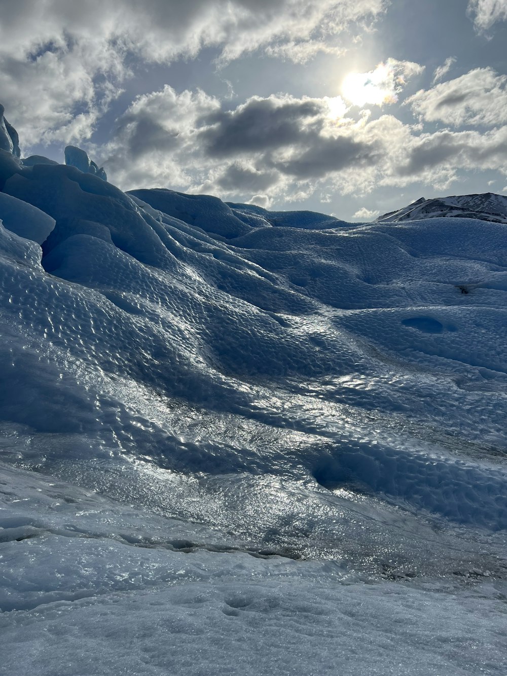 a large glacier in the middle of a snowy landscape