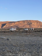 a group of vehicles parked in a desert