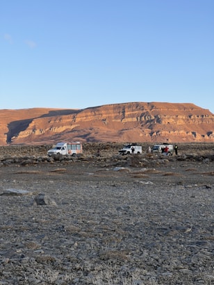 a group of vehicles parked in a desert