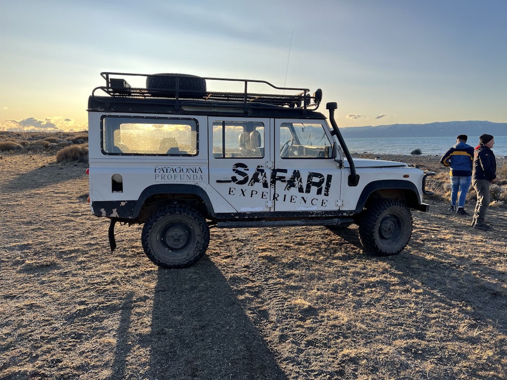 a white vehicle with a rack on top of it