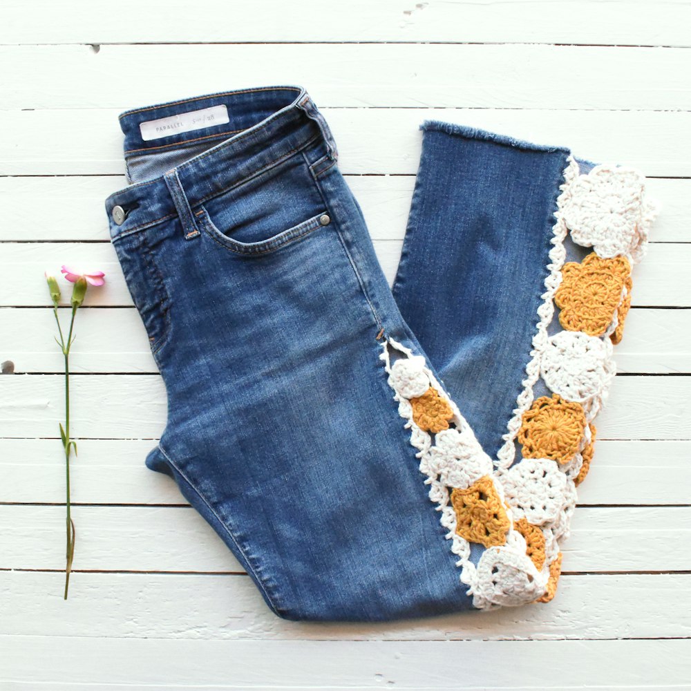 a pair of jeans with a flower
