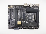 A computer motherboard featuring various components such as RAM slots, CPU socket, PCI slots, and numerous connectors for peripherals. It has a sleek, dark design with visible circuitry and branding including 'ASUS' and 'ProArt'. Ports for USB, HDMI, and other connectors are visible along the top edge.