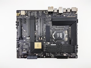 A computer motherboard featuring various components such as RAM slots, CPU socket, PCI slots, and numerous connectors for peripherals. It has a sleek, dark design with visible circuitry and branding including 'ASUS' and 'ProArt'. Ports for USB, HDMI, and other connectors are visible along the top edge.