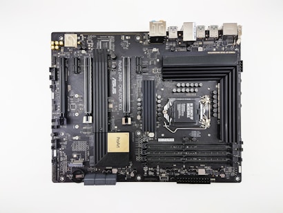 A computer motherboard featuring various components such as RAM slots, CPU socket, PCI slots, and numerous connectors for peripherals. It has a sleek, dark design with visible circuitry and branding including 'ASUS' and 'ProArt'. Ports for USB, HDMI, and other connectors are visible along the top edge.