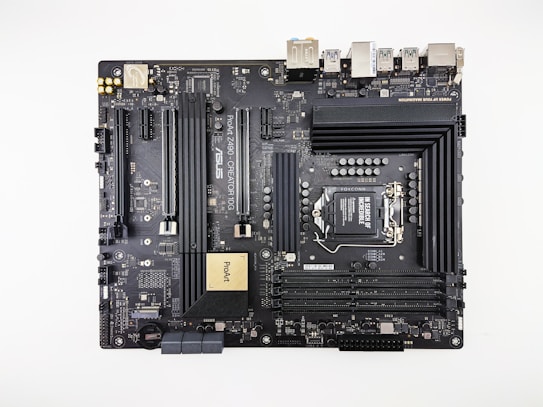 A computer motherboard featuring various components such as RAM slots, CPU socket, PCI slots, and numerous connectors for peripherals. It has a sleek, dark design with visible circuitry and branding including 'ASUS' and 'ProArt'. Ports for USB, HDMI, and other connectors are visible along the top edge.