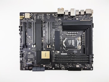 A computer motherboard featuring various components such as RAM slots, CPU socket, PCI slots, and numerous connectors for peripherals. It has a sleek, dark design with visible circuitry and branding including 'ASUS' and 'ProArt'. Ports for USB, HDMI, and other connectors are visible along the top edge.