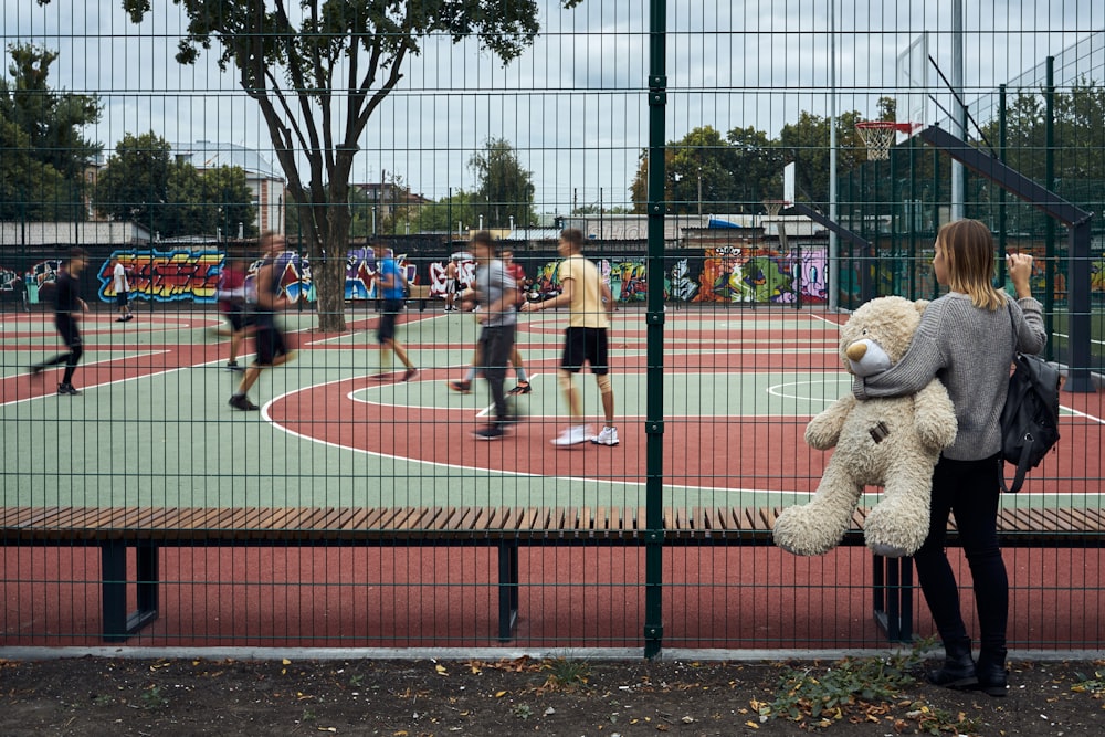 a person in a bear garment standing on a tennis court