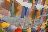 A panoramic view of a bustling port connecting Nepal, China, India, Turkey, and the UAE with colorful flags fluttering.