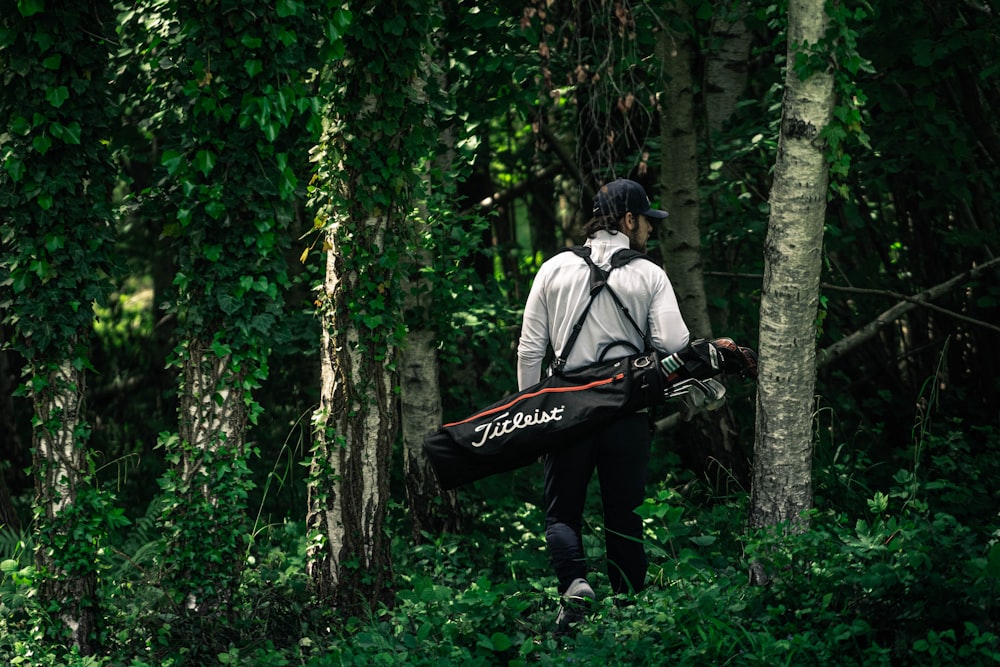 a person with a rifle in the woods