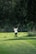 a person swinging a golf club