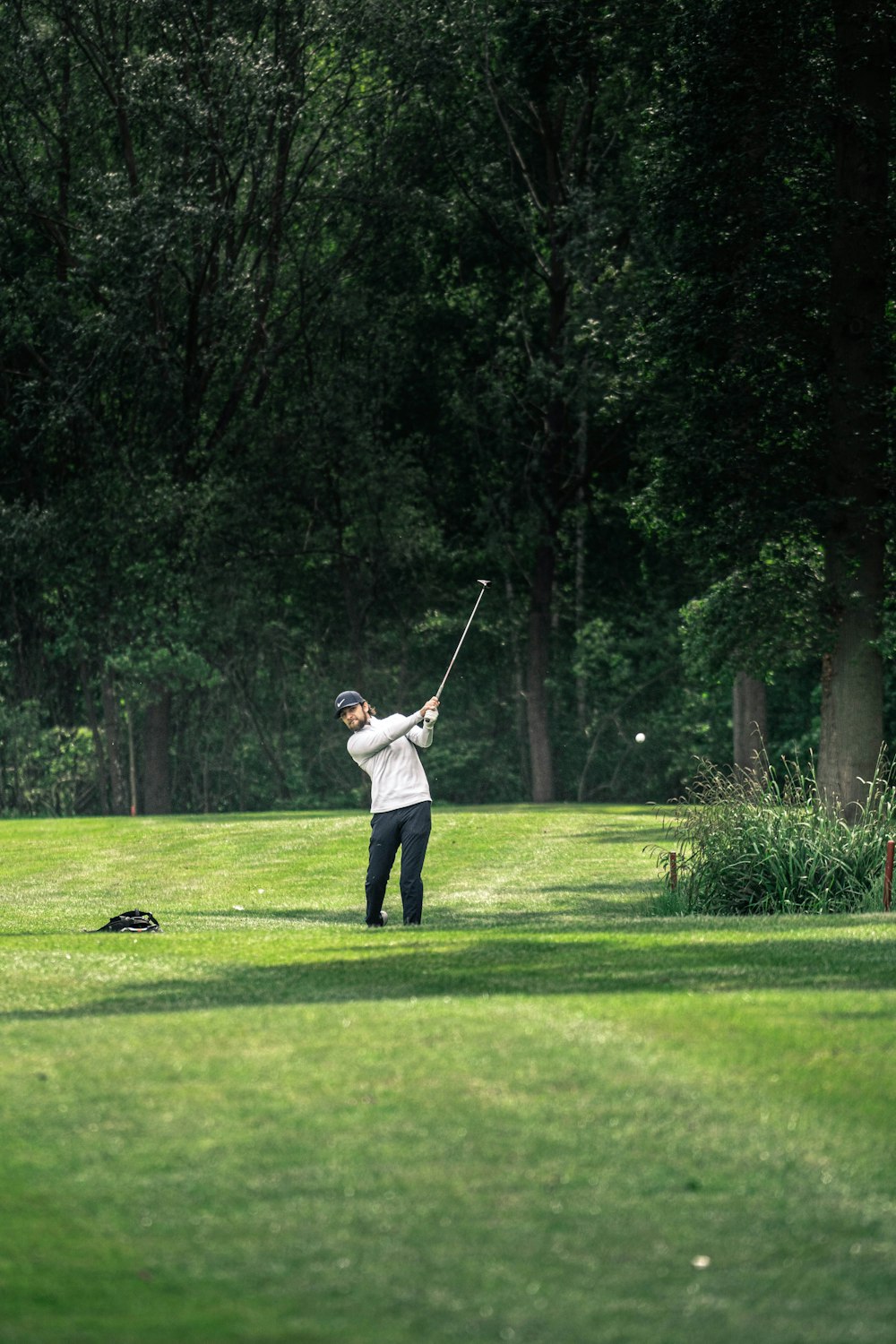 a person swinging a golf club