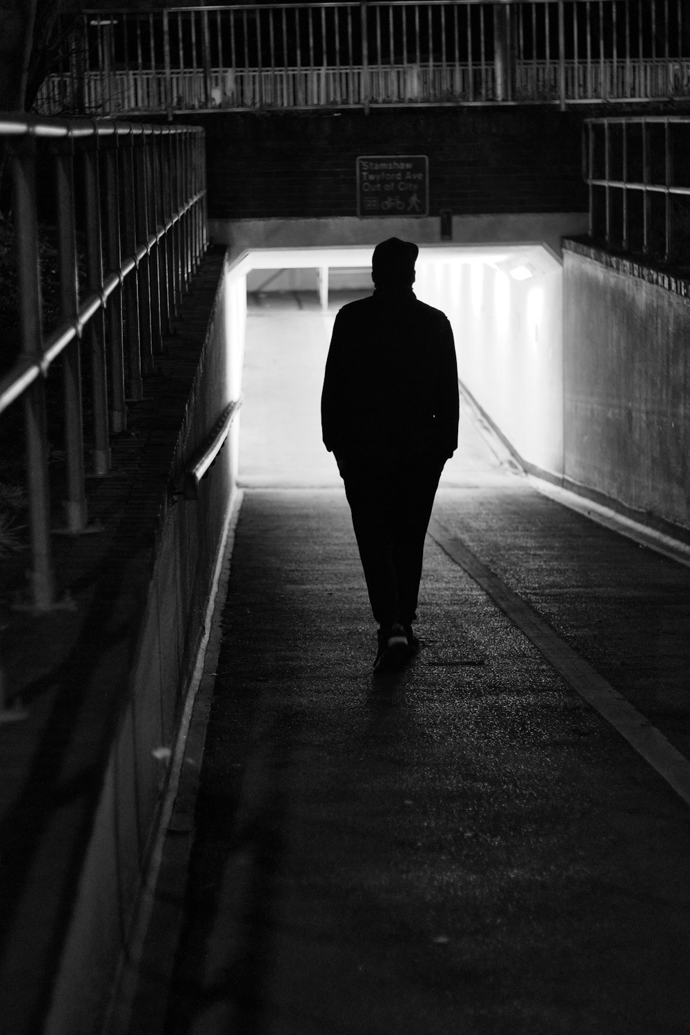 a man walking down a dark hallway